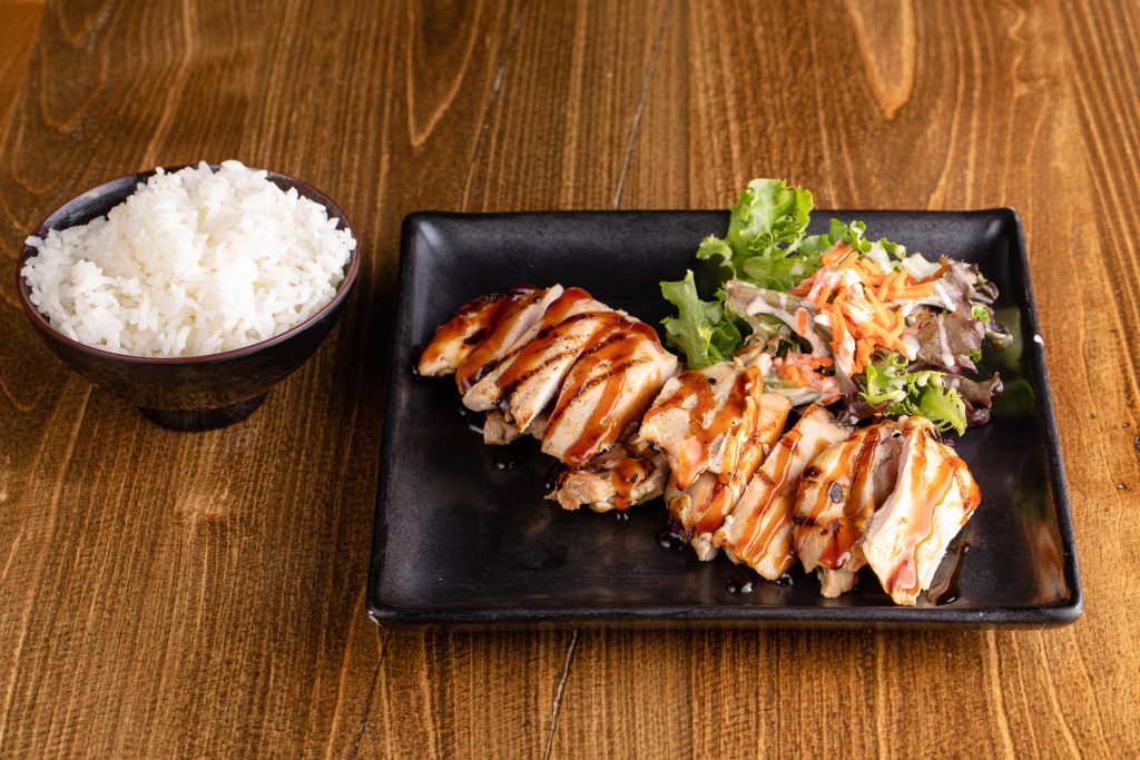 Grilled chicken with teriyaki sauce, side of rice and a salad
