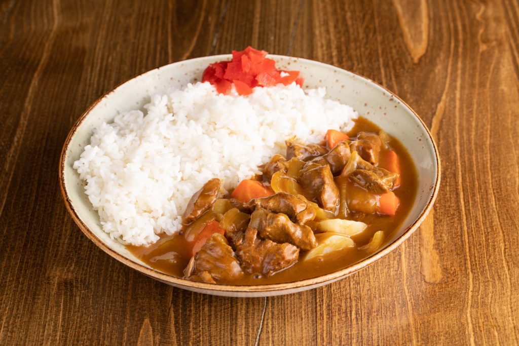Beef, potatoes, carrots, onions in curry sauce and rice. Add a breaded pork cutlet