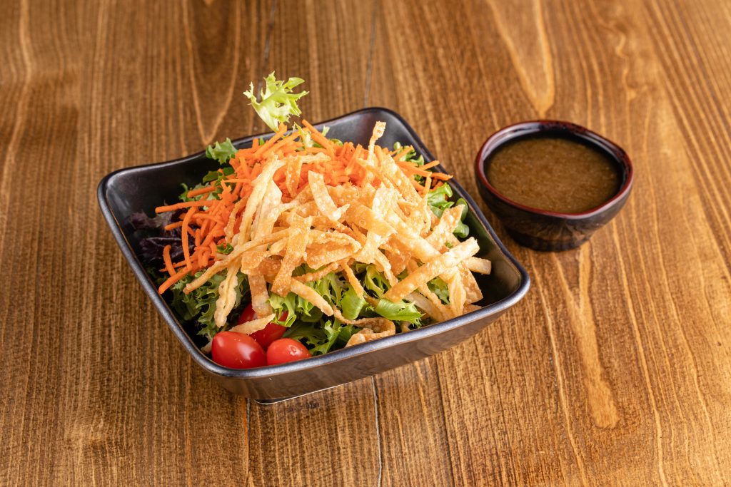 Mixed greens, onion-soy dressing, wonton strips