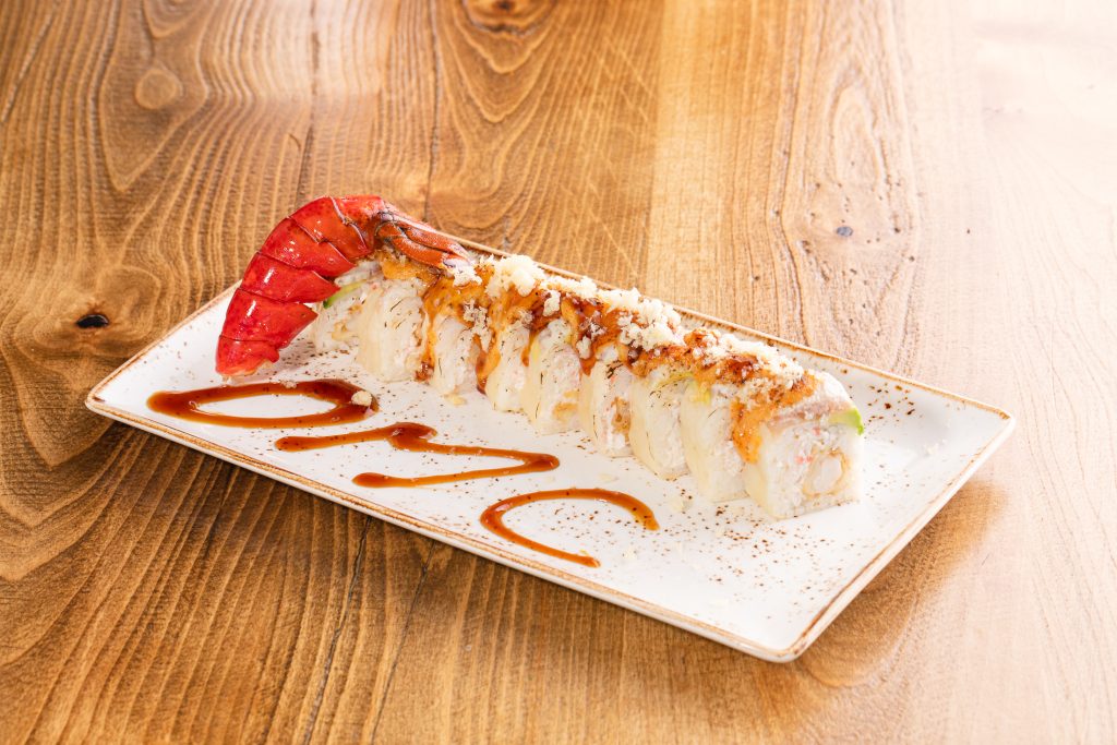 Tempura lobster, avocado, crab mix, white tuna, soy wrap, sauce, torched, tempura bits