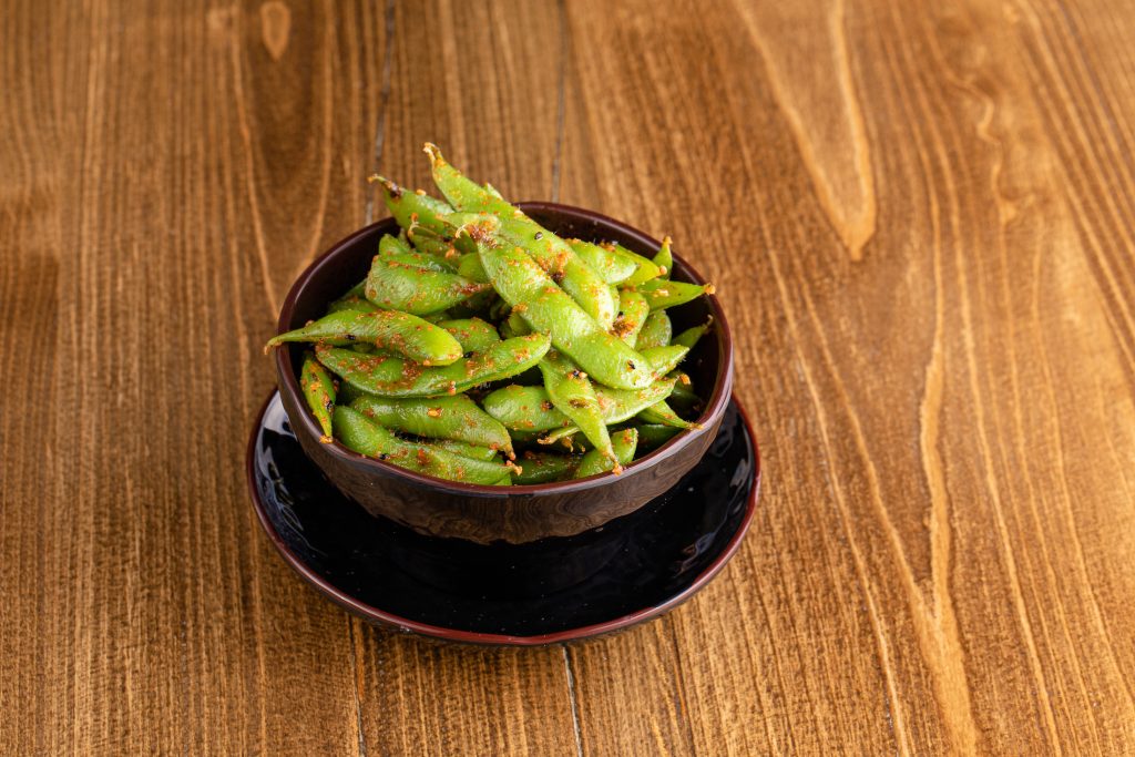 A bowl of edamame with spicy chili seasonings