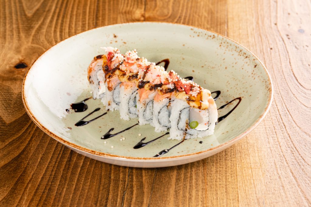 Scallop, shrimp, crab mix, asparagus, cream cheese, salmon, lobster, balsamic, unagi sauce, Hang Loose sauce, arare