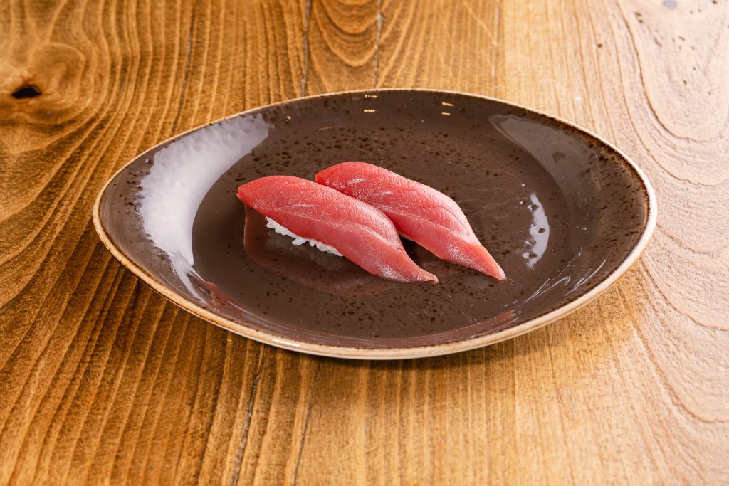 Two tuna nigiri on a plate