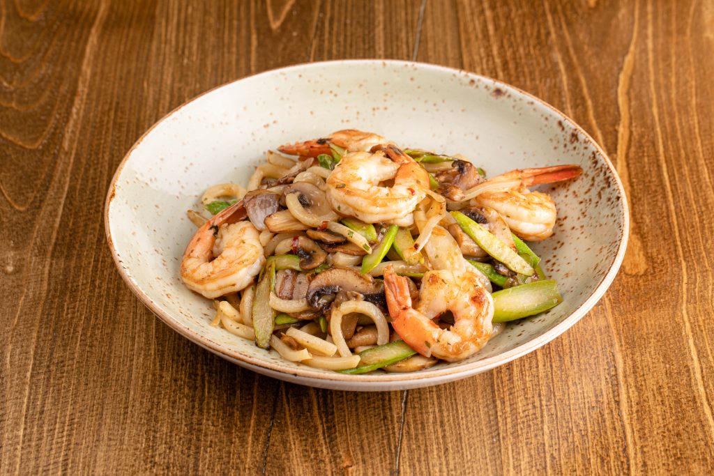 Udon noodles sautéed in olive oil and garlic with prawns, asparagus, mushrooms, onion
