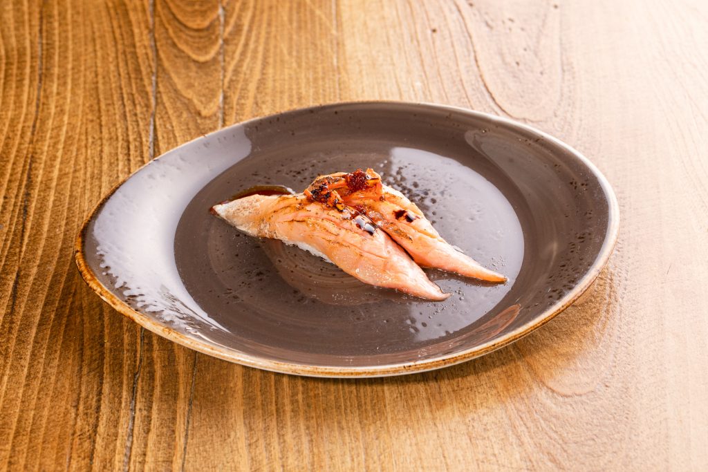 Two Salmon torched, truffle wasabi sauce, balsamic, ponzu, chili garlic almond sauce nigiri