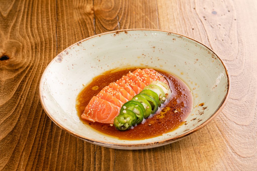 Thinly sliced salmon, citrus soy dressing, jalapenos, sesame seeds