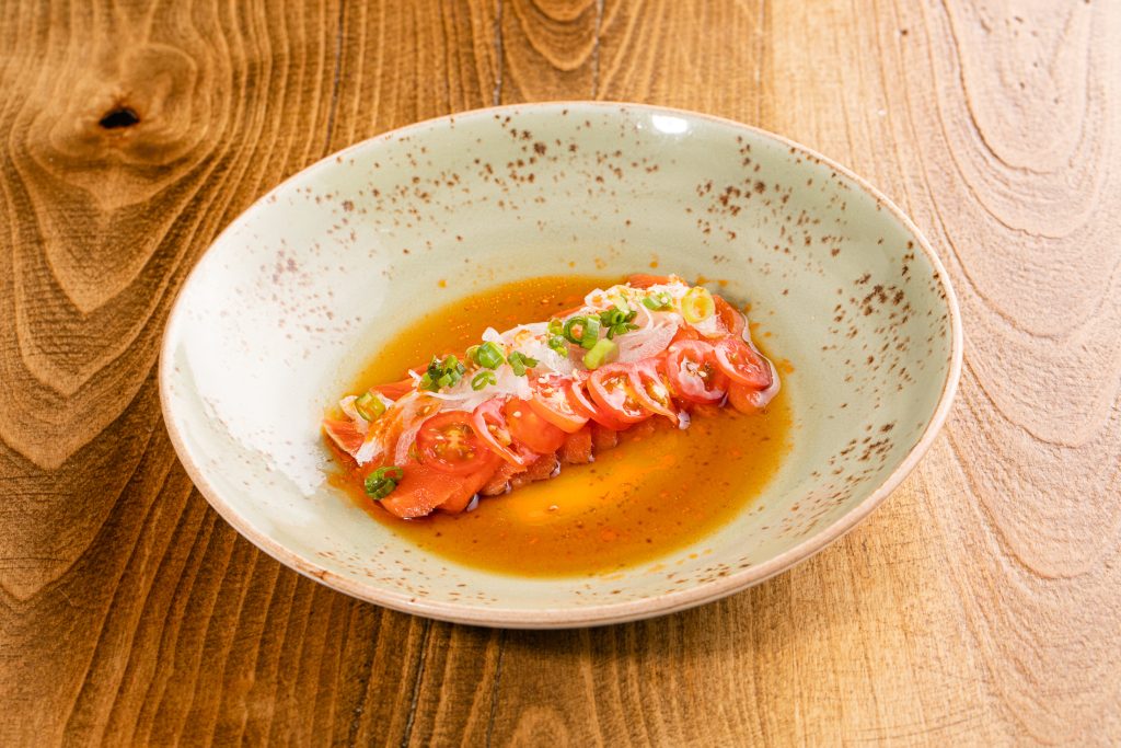 Ocean trout, cherry tomatoes, white and green onion, citrus soy, chili oil, sesame seeds