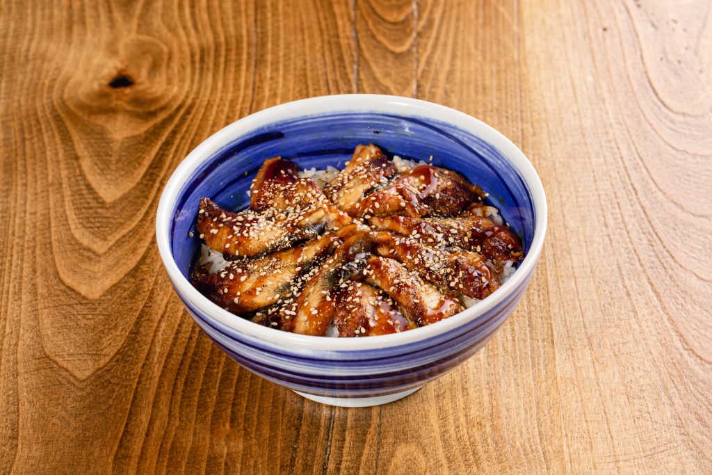 Grilled eel over steamed rice with sesame seeds